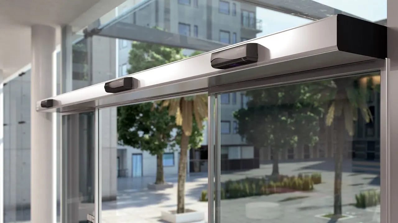 ASSA ABLOY SL500 sliding door operator installed on glass sliding doors